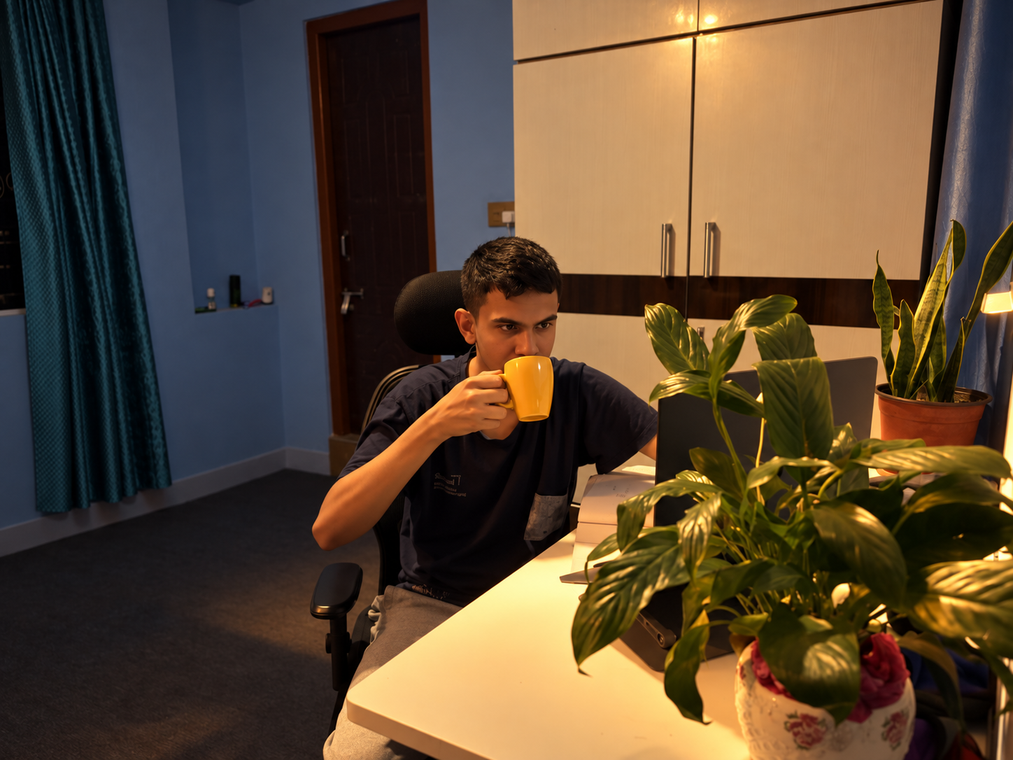 Me at my desk, with my yellow mug, books and plants